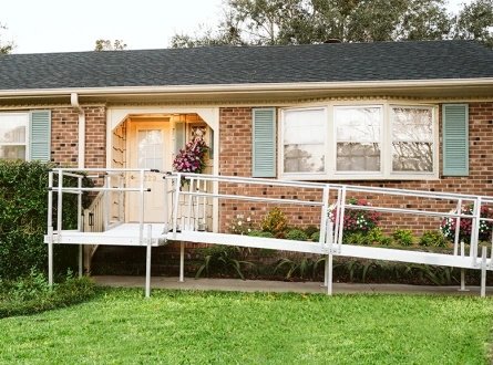 A Harmar® modular ramp outside of a brick house.