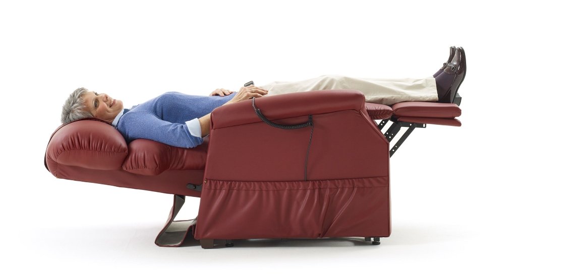 A Fully Reclined Smiling Elderly Woman On A Lift Chair