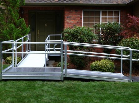 An EZ-ACCESS® modular ramp outside of a brick house.