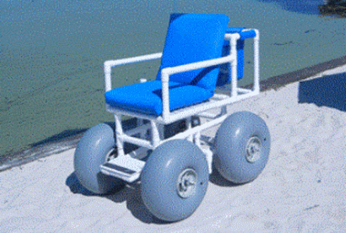 A Beach Wheelchair Parked On The Sand At The Beach 