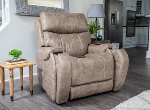 A beige power lift chair next to a small wood table next to the kitchen