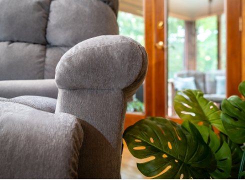 Close up on the arm rest of a gray Pride® Oasis lift chair